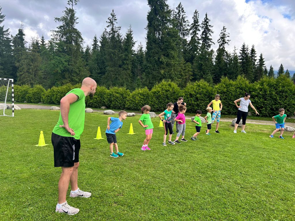 dzieci i dorośli robią trening na świeżym powietrzu